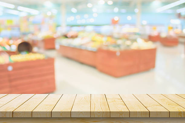 istock Empty wood table top with supermarket blurred background for product display 2243696360