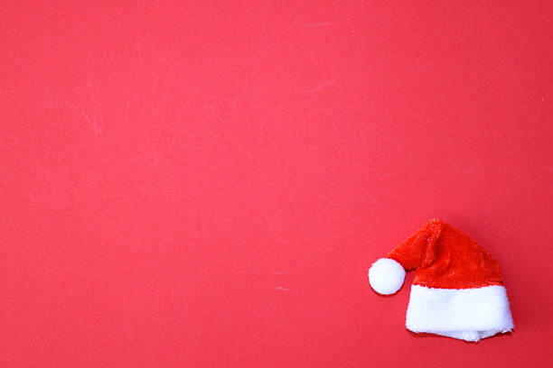 istock Santa Claus hat on red background. 2243697280