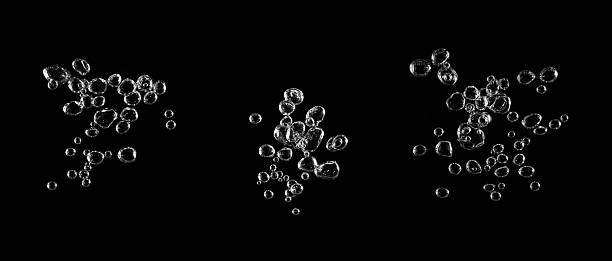 istock Clear water bubbles rising in black background, symbolizing freshness, purity, and oxygen concept. Perfect for design, clean energy visuals, beverage ads, or abstract creative digital artwork. 2243697771