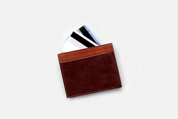 istock Brown leather wallet with credit cards partially visible. 2243701488