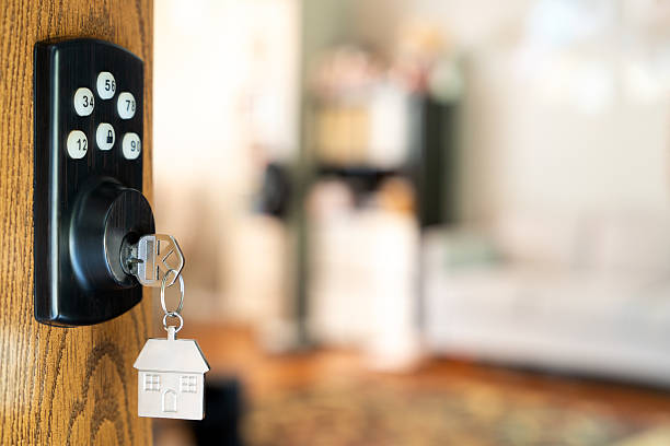 istock House key with house shape keychain in smart lock 2243702617
