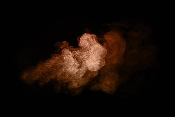 istock Abstract orange smoke cloud isolated on black background, artistic vapor texture in motion for creative design, fire energy concept, explosion dust, or magical mist illustration background. 2243703170