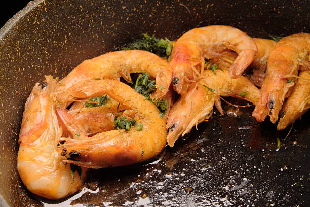 istock Sizzling Shrimp in Cast-Iron Skillet, Garnished with Fresh Herbs 2243705852