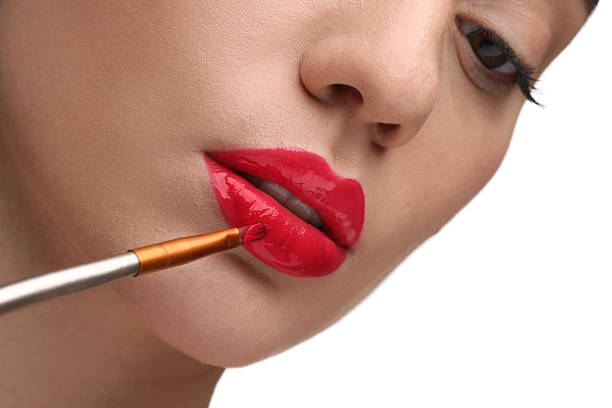 istock Woman applying lip gloss on white background, closeup 2243707315