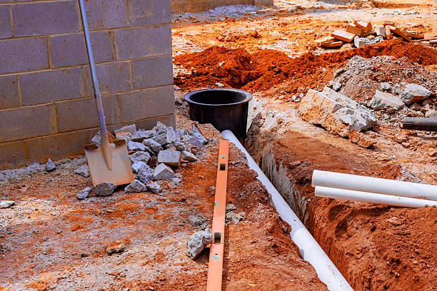 istock Excavation and installation of drainage system in construction site during daytime work 2243707813