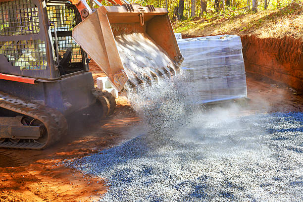 istock Track loader machinery dumps gravel on construction site during works day 2243707839