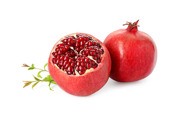 istock Fresh ripe pomegranates and green leaves isolated on white 2243707933
