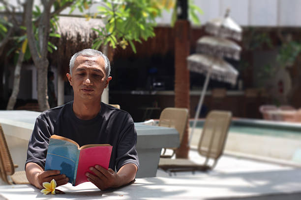 older man reading in his living room