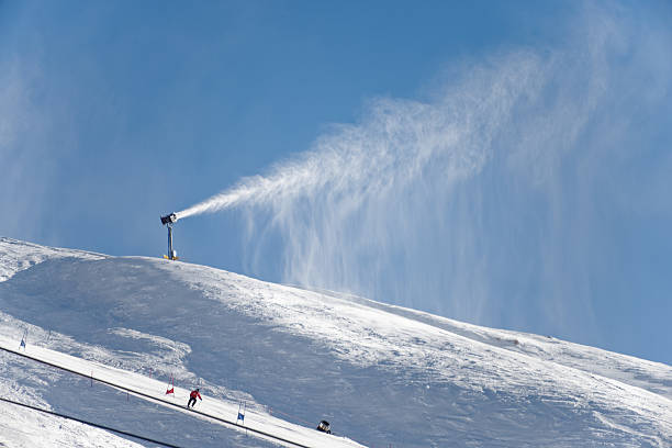 A ski field gets a top of of snow from the artificial snow maker