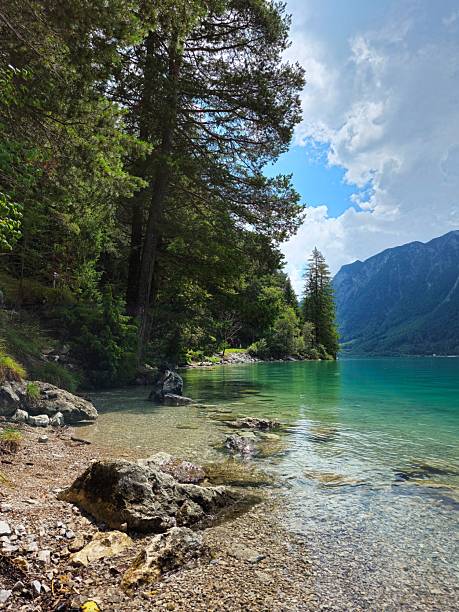 istock Serene lakeside with turquoise waters and lush greenery. 2243714670