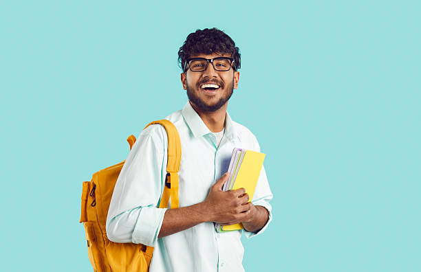 istock Young happy Indian man student with backpack and books in hands rejoicing at entering university 2243716793