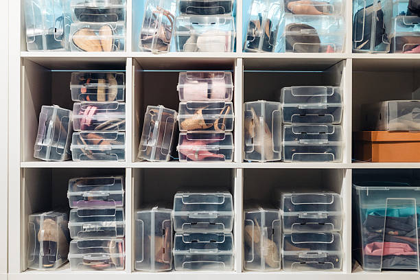 istock Closet shelving with rows of shoes organized inside transparent plastic storage boxes 2243717895