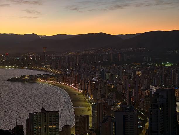istock sunset glow reflecting off shoreline while skyscrapers cast shadows behind bustling streets 2243718867