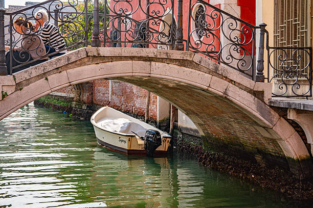 Gondola Sailing in the Venetian Canals with tourist, Venice, Italy.