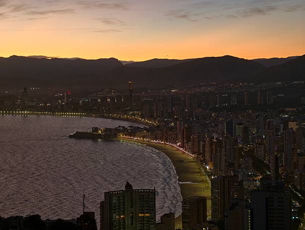 istock bright shoreline and tranquil ambiance, evening at bay with illuminated walkways and peaceful waters 2243720121