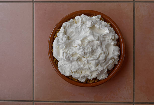 Fluffy whipped creams tops off a banoffee pie