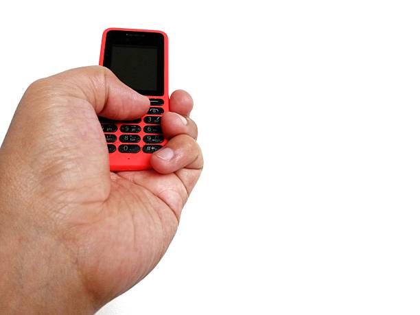 istock Jakarta, Indonesia, hand pose holding an old cellphone 2243722725