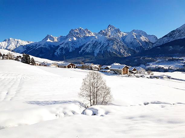 istock Fairytale winter landscape with snow-covered fields and Swiss mountains under a deep blue sky in the Engadin, Switzerland 2243723777