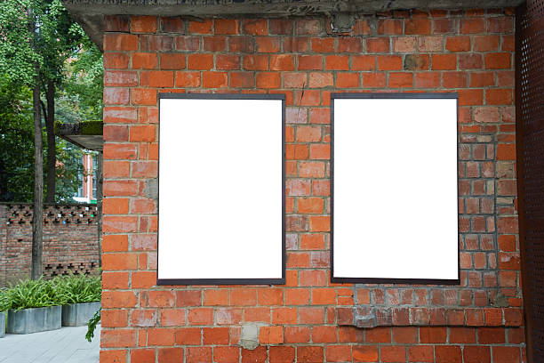 istock Double blank white posters on red brick wall. Urban background with copy space for advertisement. 2243724285