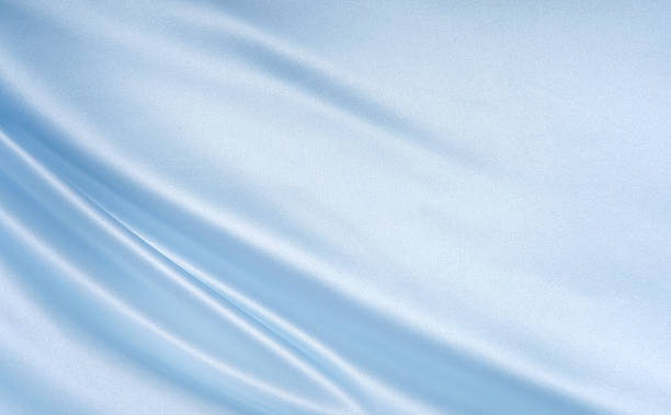 istock Pale blue silk fabric with gentle waves, copy space 2243727097