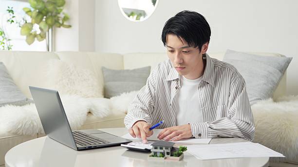 istock Asian man considering real estate 2243727142