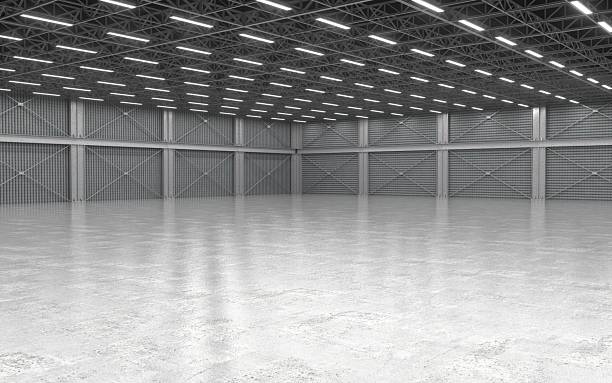istock Large empty industrial warehouse with concrete floor and ceiling lights 2243728659