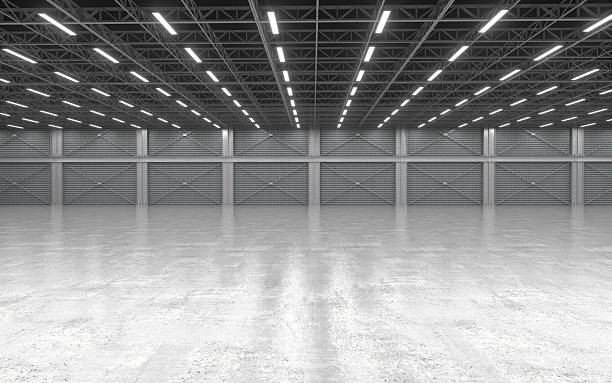 istock Large empty industrial warehouse with concrete floor and ceiling lights 2243728666