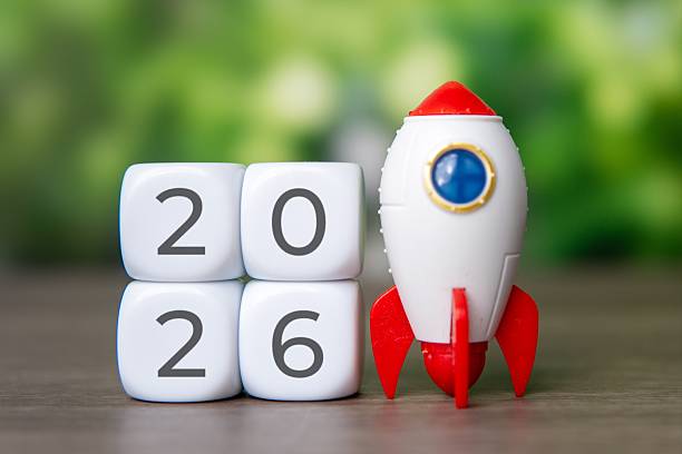 istock A toy rocket stands next to dice stacked to display the year 2026. 2243728977