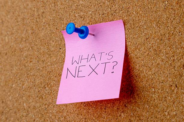 istock Note with the words WHAT'S NEXT? pinned to a cork board. 2243729063