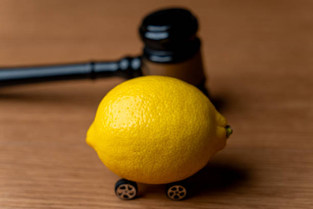 istock A lemon with small wheels placed near a judge's gavel. 2243729084