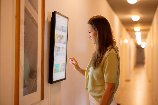 istock Woman interacting digital smart display in hallway 2243729208