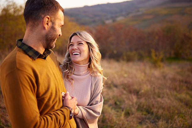 istock Happy couple talking in autumn day on a hill. 2243734598