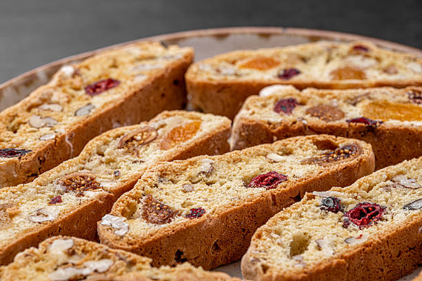 istock Italian Almond Biscotti biscuits in a rustic home made pottery bowl. Studded with almonds and cranberries, these twice-baked treats are aromatic and inviting. Ideal. 2243734621