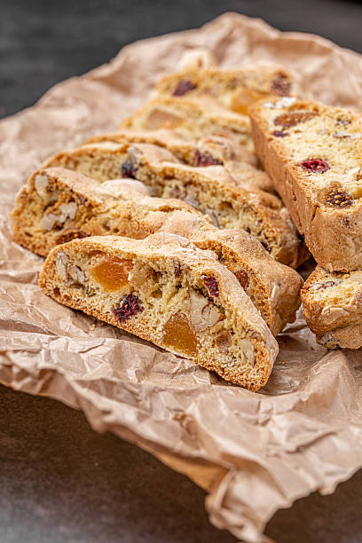 istock Italian Almond Biscotti biscuits in a rustic home made pottery bowl. Studded with almonds and cranberries, these twice-baked treats are aromatic and inviting. Ideal. 2243734628