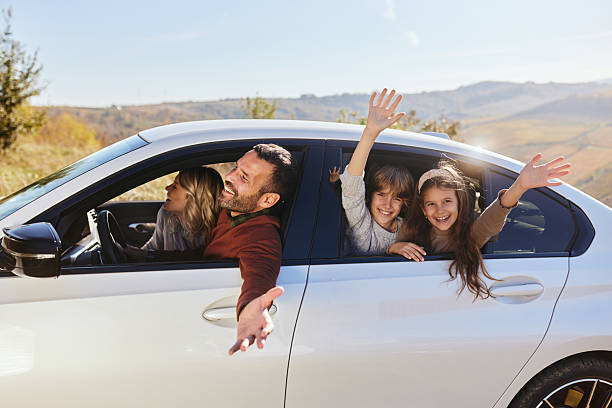 istock Cheerful family having fun during a trip by a car. 2243734693