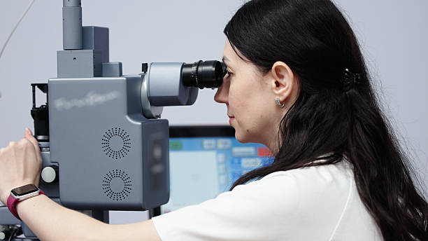 istock Female ophthalmologist examining patient's vision using advanced optical equipment in a clinical setting 2243734775