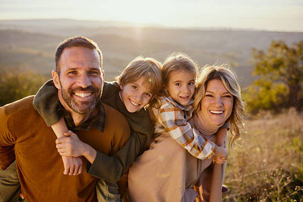 istock Happy family having fun while piggybacking in autumn day. 2243734832