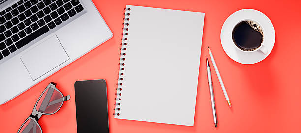istock Modern red desk or desktop with notepad and accessories 2243735916