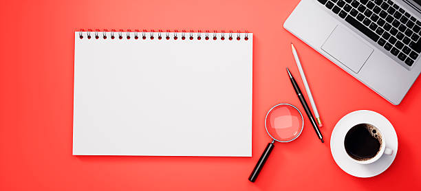 istock Modern red desk or desktop with notepad and accessories 2243735918