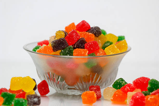 Bright and colorful sugar-coated tutti frutti cubes served in a glass bowl, perfect for desserts and sweets.