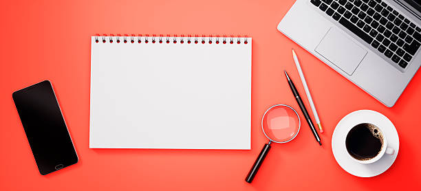 istock Modern red desk or desktop with notepad and accessories 2243736001