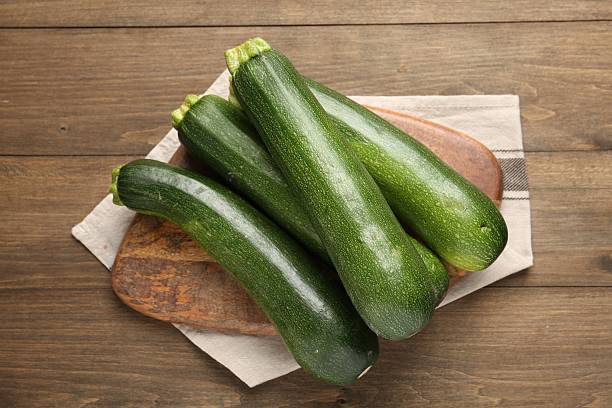 istock Fresh ripe zucchinis on wooden table, top view 2243736106