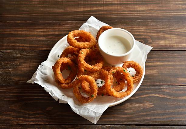 istock Heap of deep fried onion rings with sauce 2243736570