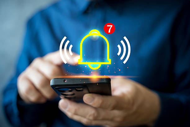 istock Smartphone notification alert concept with glowing bell icon and new message symbol for digital reminder 2243737705
