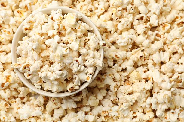 istock Tasty popcorn and bowl as background, closeup 2243739024