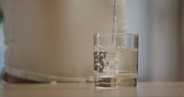 istock Pouring clear water into a transparent glass cup 2243741009