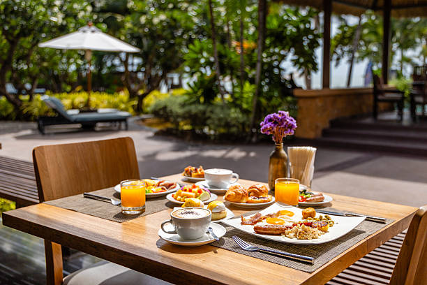 istock Outdoor breakfast setting with fresh juice, coffee, and pastries on 2243742699