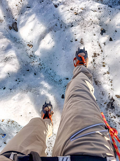 istock Mountaineer Wearing Crampons Walking on Snowy Terrain 2243743951