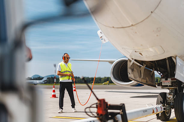 istock Determined Hispanic Technician Managing Aircraft Systems on a Sunny Airport Tarmac 2243744137