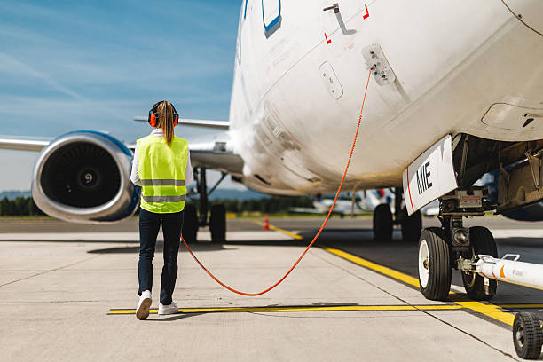 istock Concentrated Ground Crew Member Performing Vital Aircraft Systems Check on Tarmac 2243744157